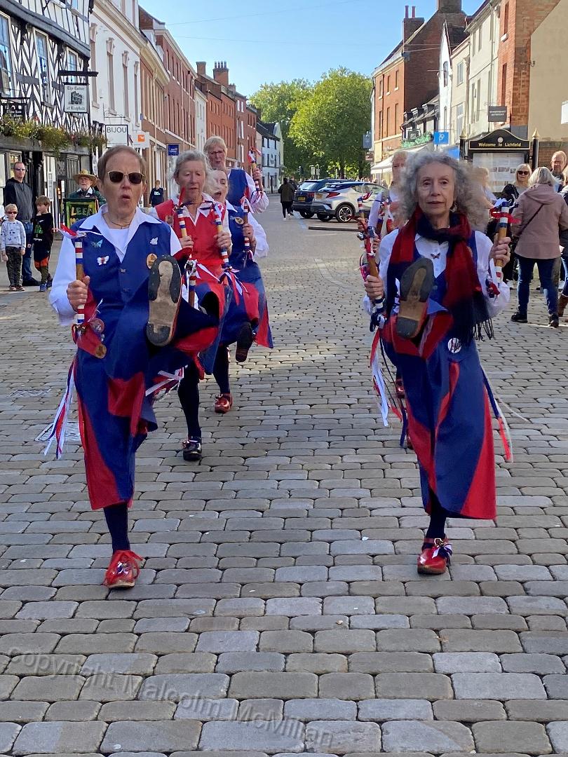 dancers with legs raised high in 2 lines 